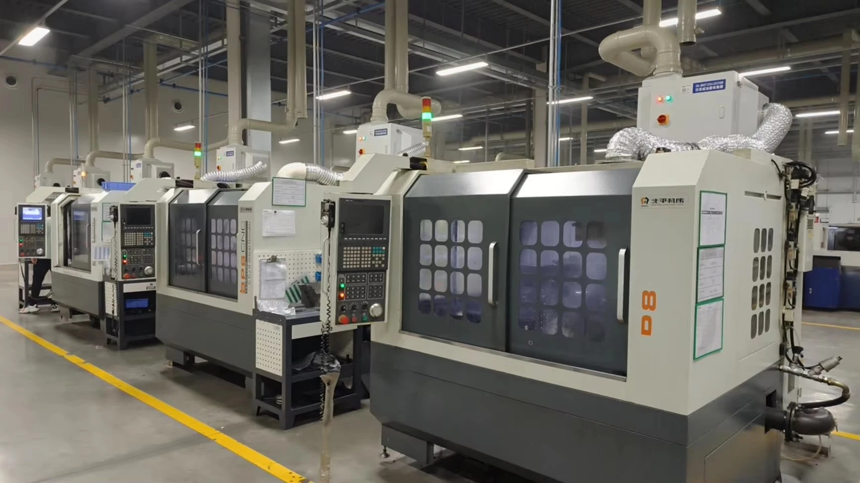 A row of enclosed CNC grinding machines — reference image for Solid Carbide Ball Nose End Mills