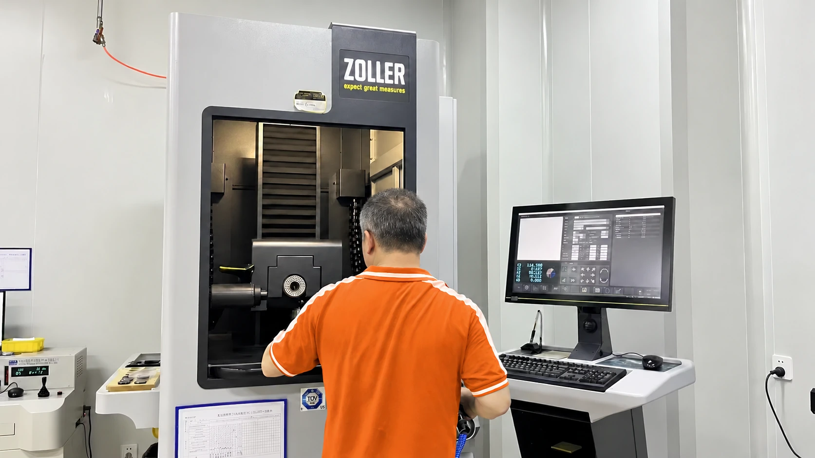 An operator setting a tool in an enclosed measuring machine — reference image for Long Shank Corner Radius End Mills