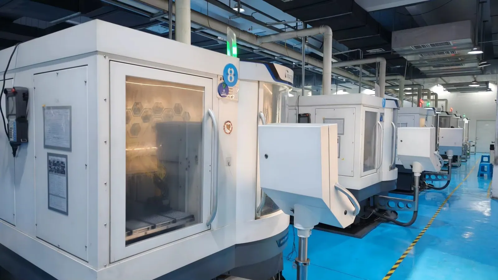 Row of enclosed machining equipment in the supplied workshop library