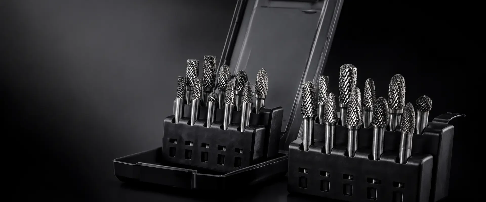 Assorted double-cut carbide burr shapes in industrial storage cases