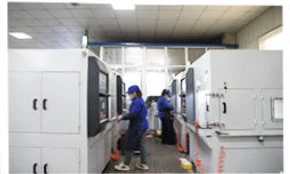 Operators at machine stations in the threading-tool workshop