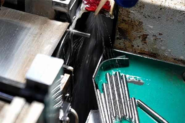 Machine detail and a tray containing elongated metal components