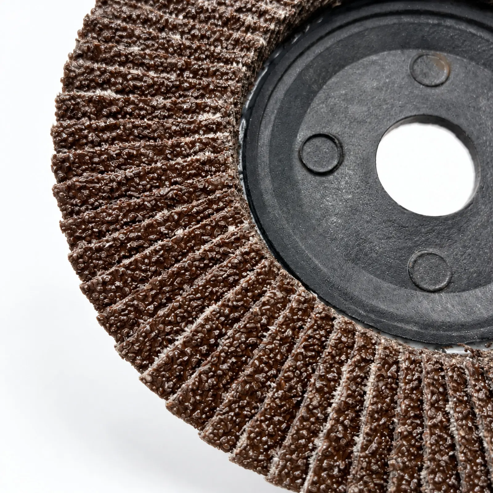 Close-up of overlapping abrasive flaps on a flap disc