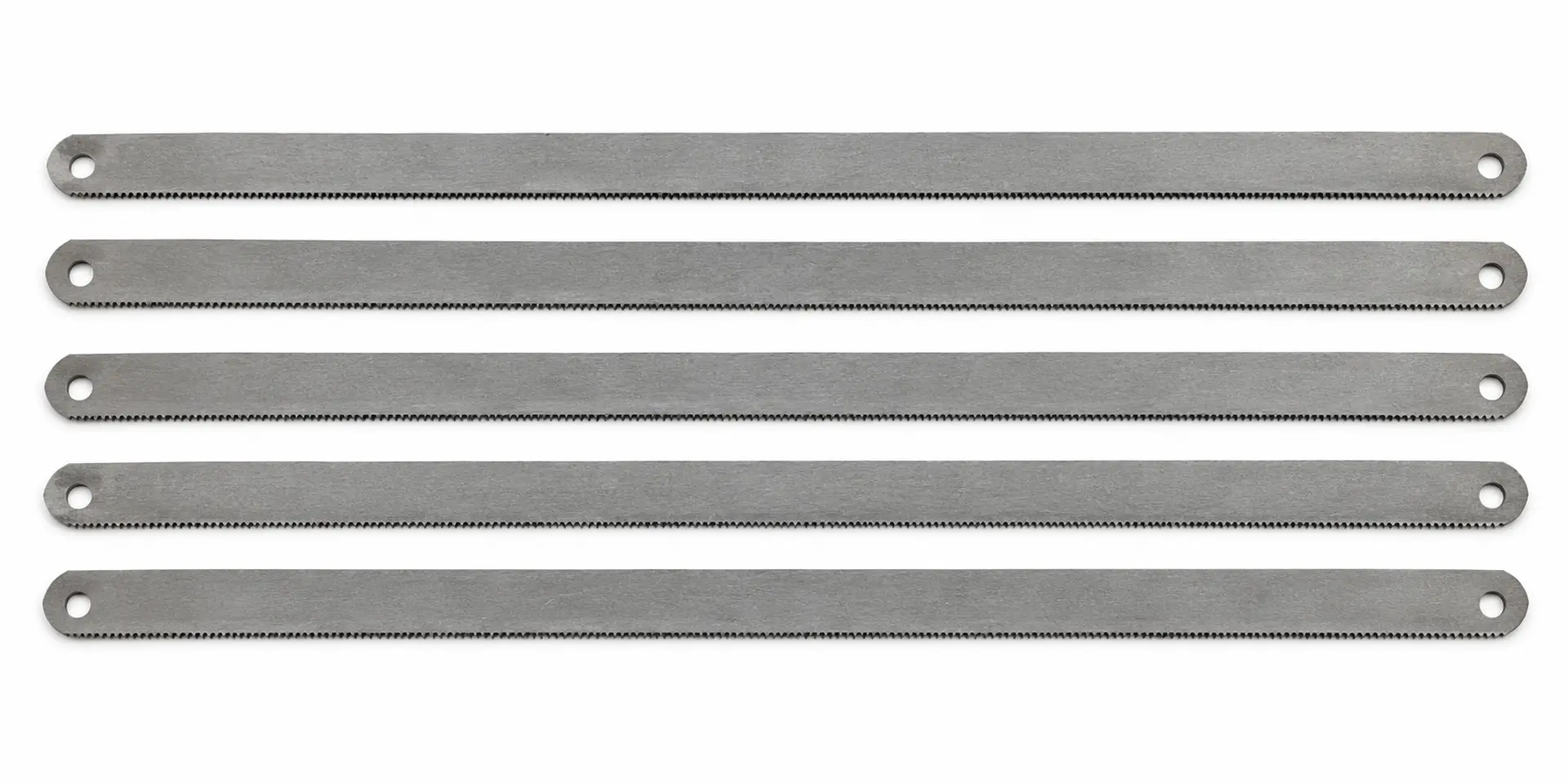 Illustrative group of hand hacksaw blades showing their full length and end mounting holes