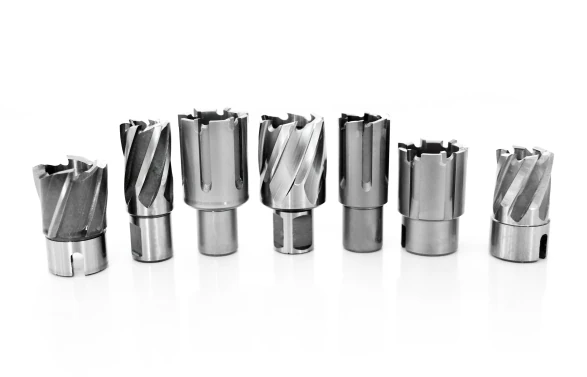 Rail hollow drill bits shown in different diameters and cutter configurations